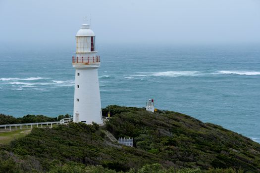 Captivating lighthouse stands on rocky coast at Aireys Inlet, capturing the serene yet powerful ocean view in Victoria, Australia.