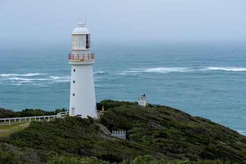 Free Captivating lighthouse stands on rocky coast at Aireys Inlet, capturing the serene yet powerful ocean view in Victoria, Australia. Stock Photo
