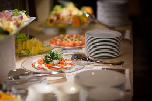 Free A beautifully arranged buffet with Caprese salad and fresh fruits on a white tablecloth. Stock Photo