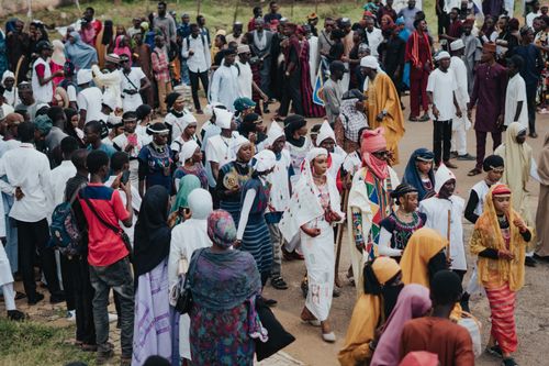Free A lively outdoor parade featuring diverse groups in traditional attire, celebrating cultural heritage. Stock Photo