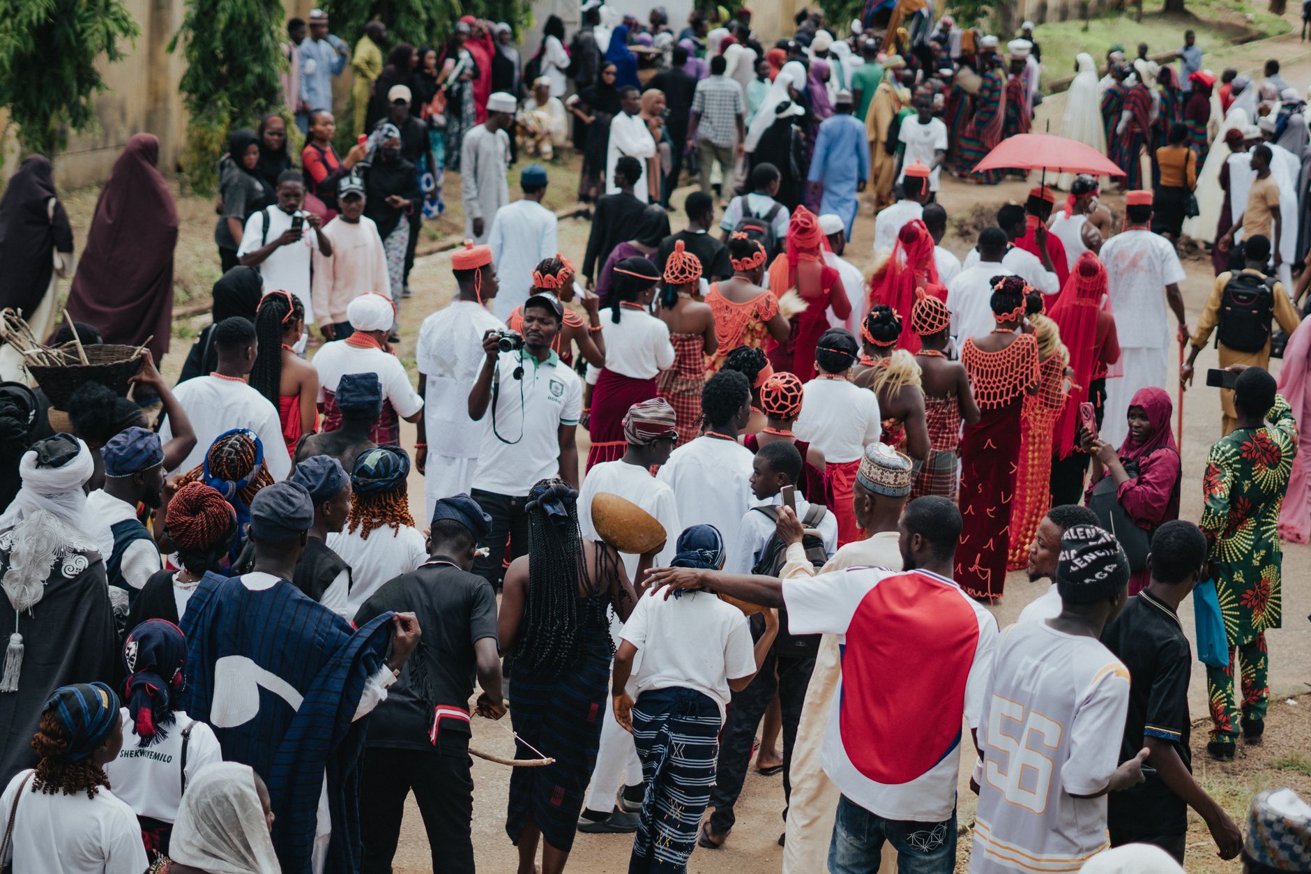 A lively cultural festival featuring diverse traditional African attire and community gathering.