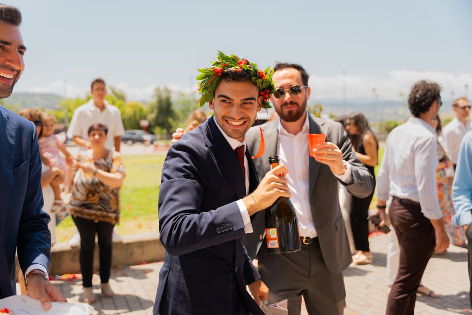 A joyful graduate celebrating outdoors with friends and family on a sunny day. Perfect for graduation-themed content.