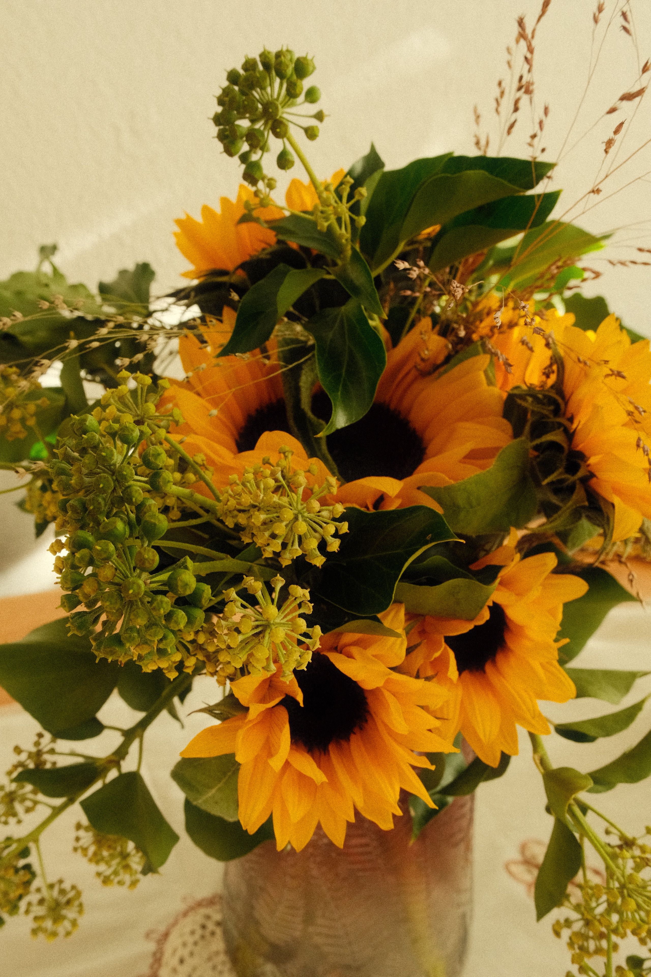 A beautiful sunflower bouquet in a vase, perfect for brightening any room.