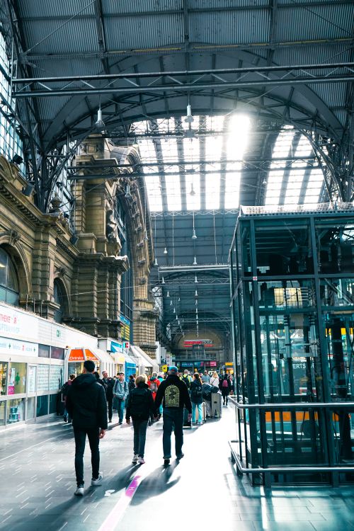 Free Crowd of travelers at Frankfurt Central Station's architectural interior. Stock Photo