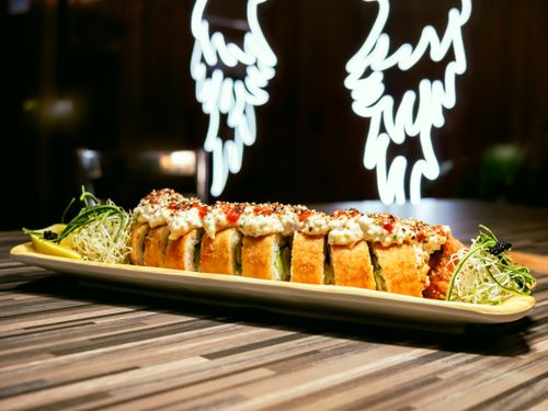 Free A visually appealing gourmet sushi roll served on a modern plate, highlighting intricate culinary artistry. Stock Photo