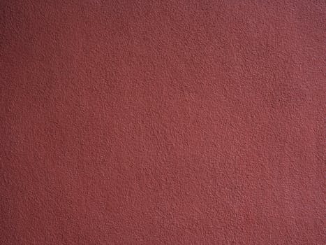 Detailed close-up view of a red textured wall perfect for backgrounds or design use.