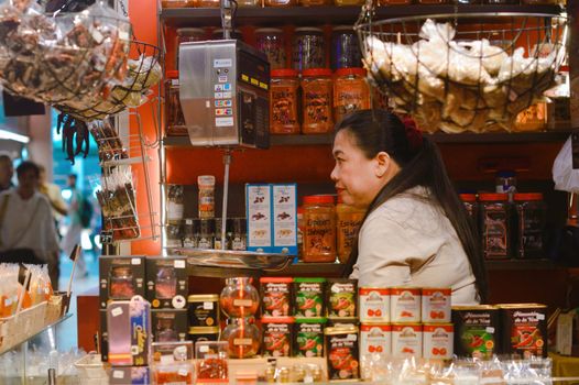 A vibrant artisan spice market stall in Barcelona, Spain, showcasing a variety of spices and food products.