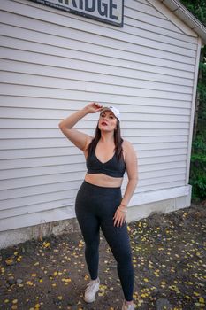 Stylish woman in activewear posing outside a building in Breckenridge, Colorado.