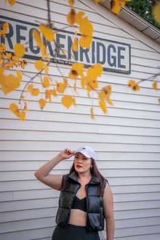 Fashionable woman poses in autumn attire. Breckenridge sign visible