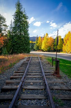 Captivating autumn scenery with railway tracks in Breckenridge, Colorado surrounded by vibrant fall foliage.
