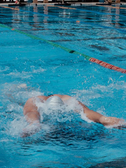 Free Swimmer executing the butterfly stroke in an outdoor pool during a competition in Aguascalientes, Mexico. Stock Photo