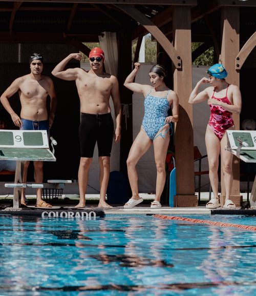 Free A group of swimmers pose confidently at an outdoor pool in Aguascalientes, ready for competition. Stock Photo
