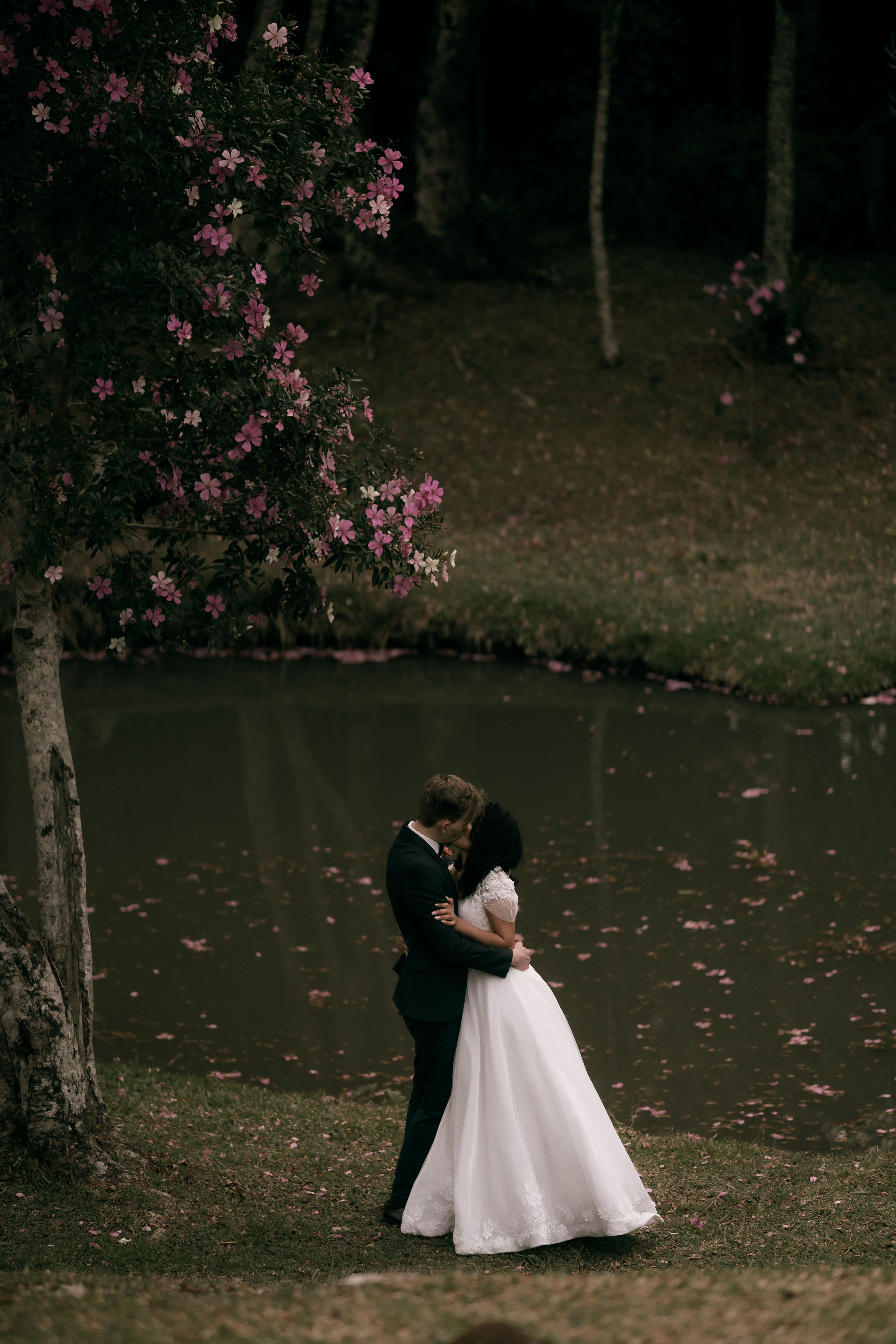 Romantic Wedding Couple Embracing Near Pond · Free Stock Photo