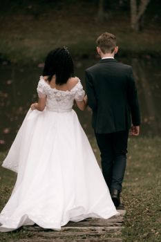 A bride and groom walk hand in hand, symbolizing unity and love.