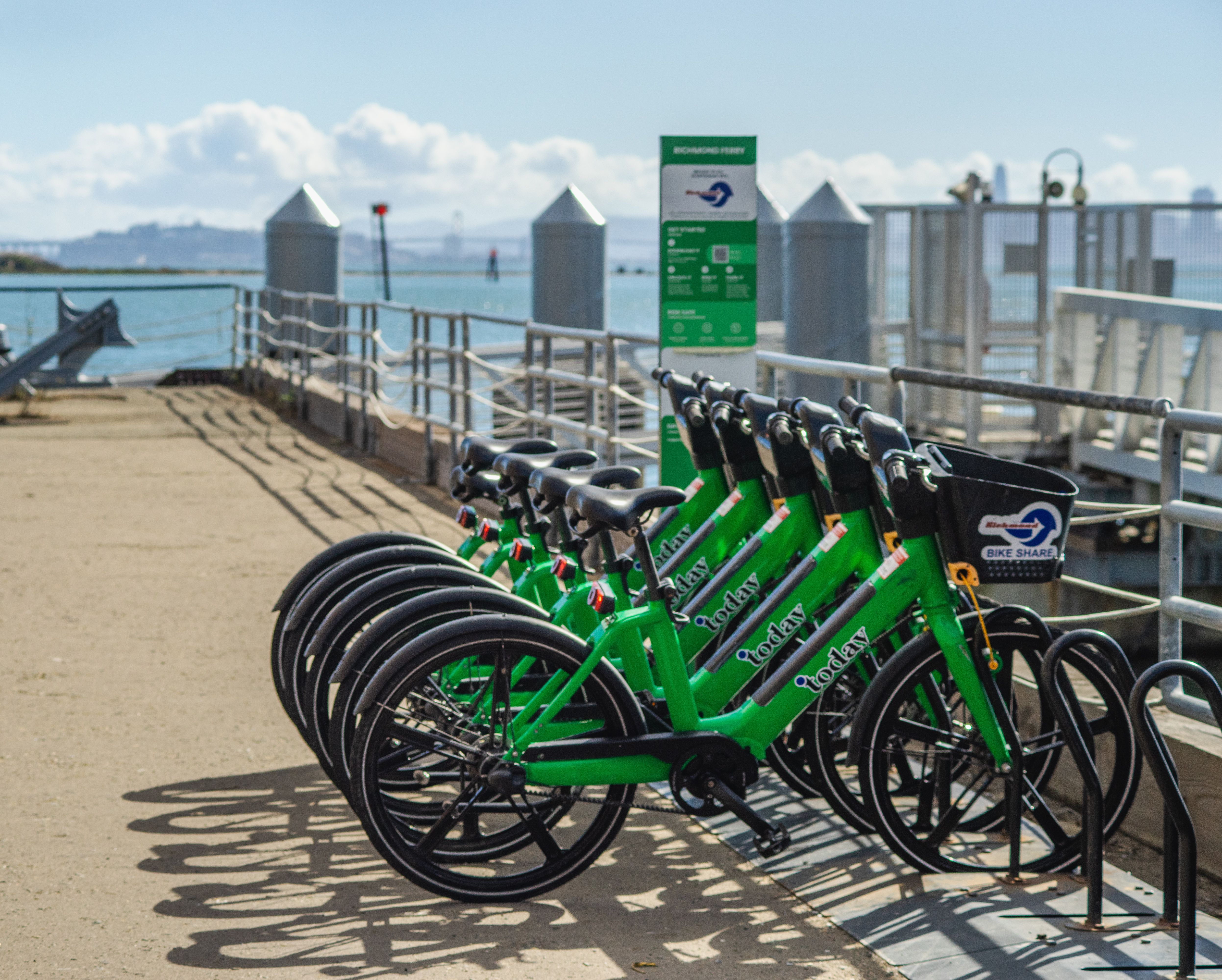 Green Rental Bikes at Scenic Waterfront · Free Stock Photo
