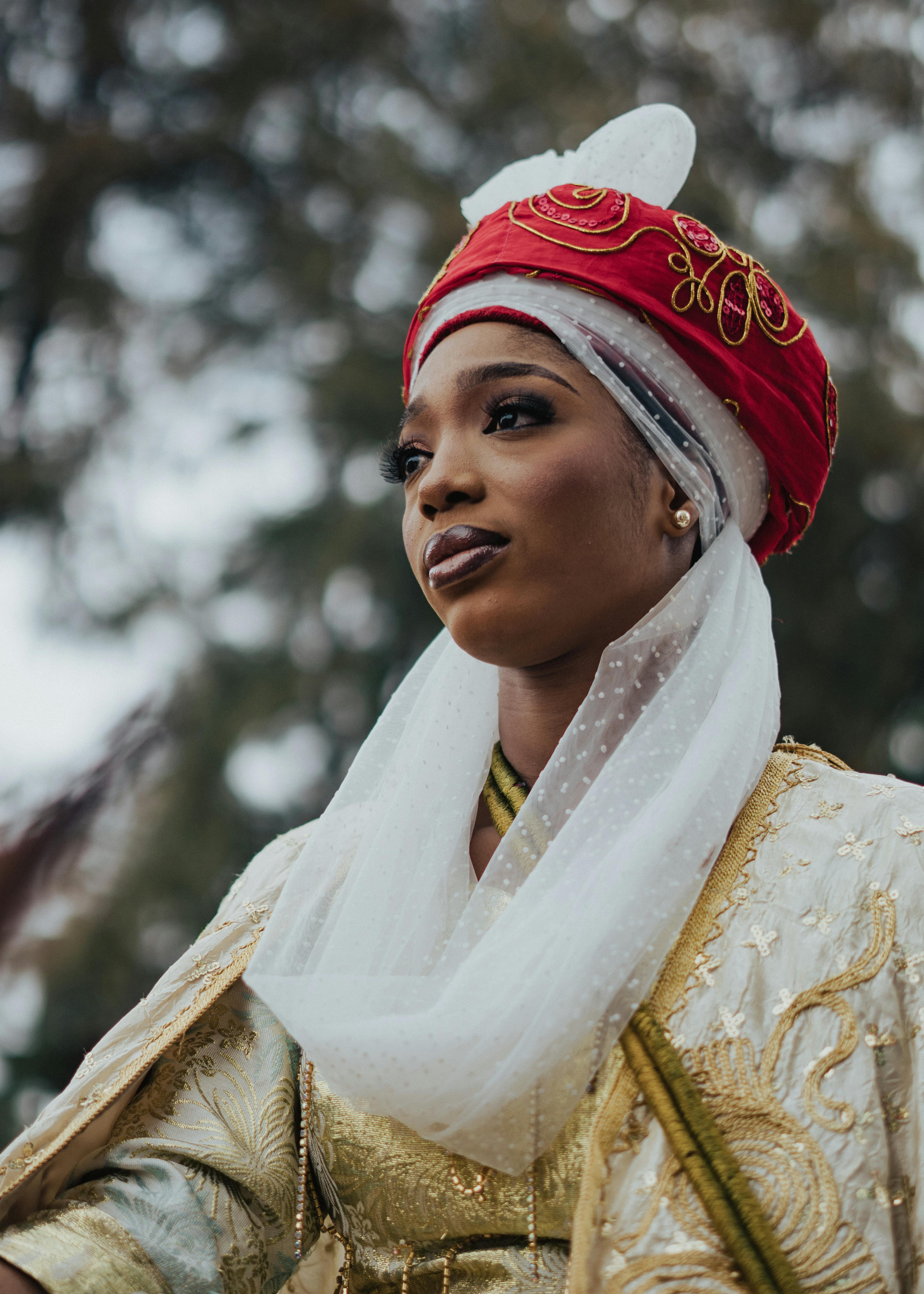Portrait of a woman in traditional attire with vibrant colors outdoors.