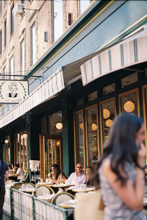 Free Outdoor city cafe with people dining and enjoying a sunny day, vibrant urban atmosphere. Stock Photo