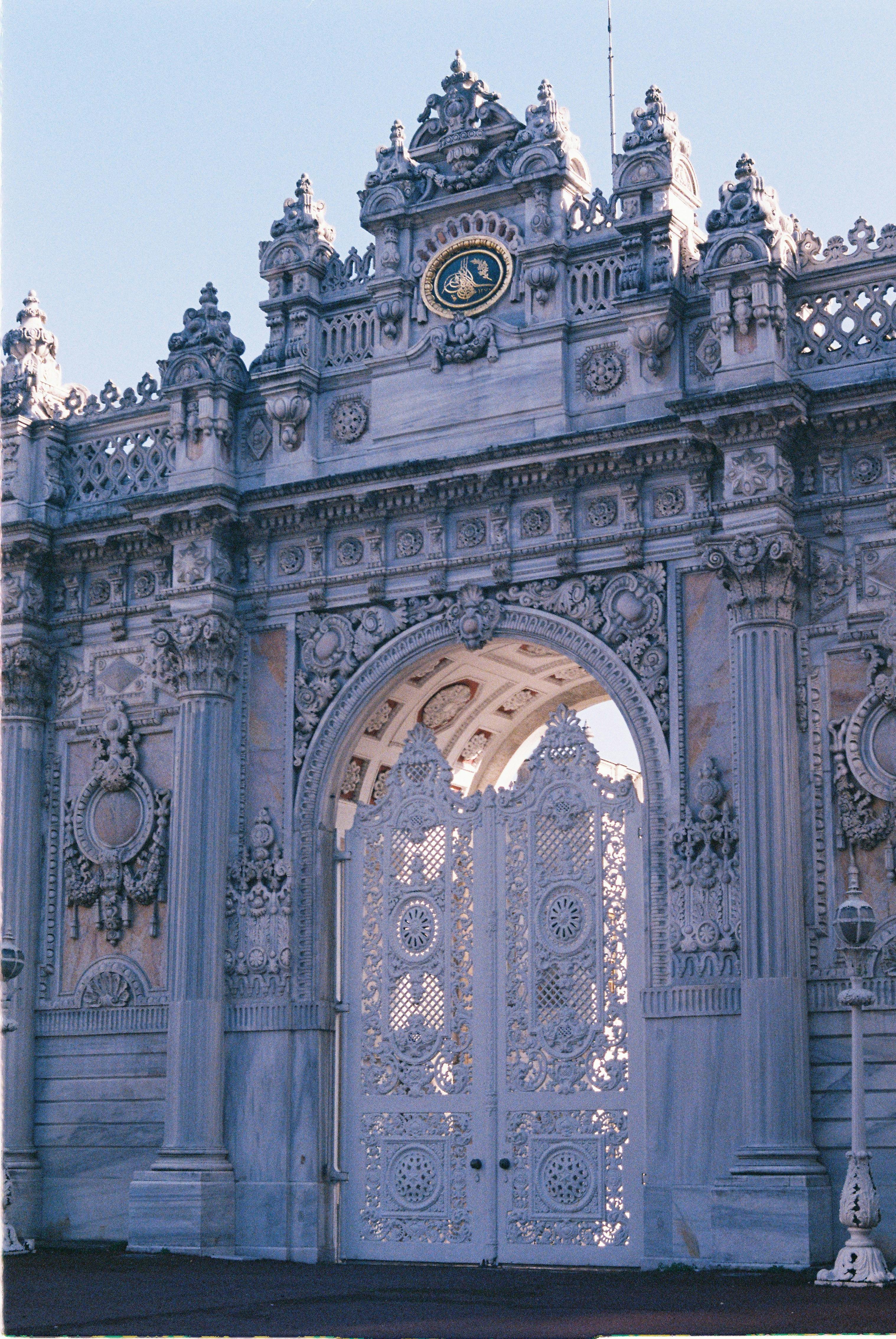 Detailed view of the ornate entrance gate of Dolmabahçe Palace in Istanbul, showcasing intricate architecture.