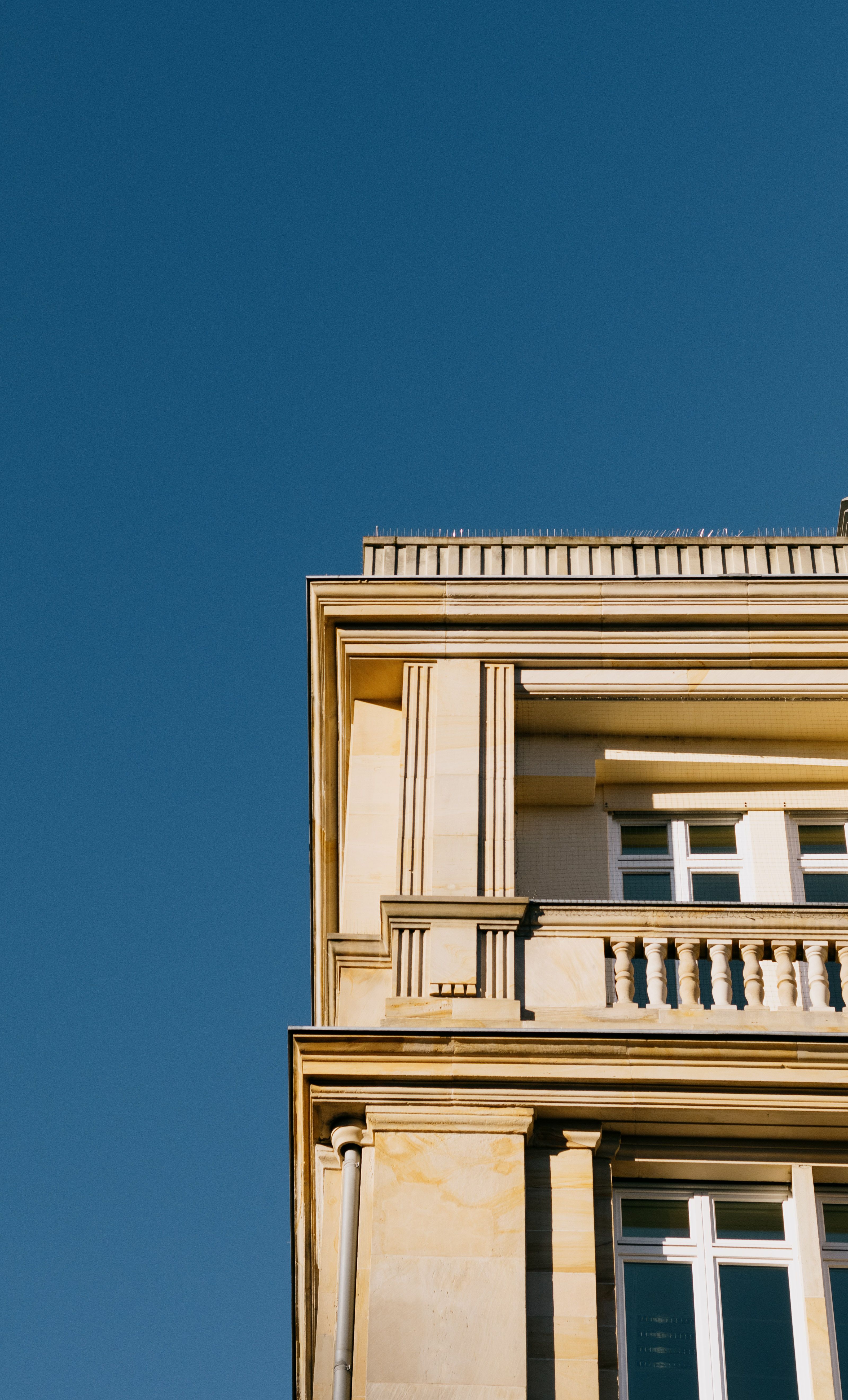 Elegant Classic Architecture Against Clear Blue Sky · Free Stock Photo