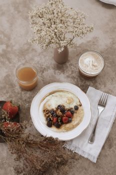 A mouthwatering breakfast setup featuring pancakes with berries, coffee, and juice.