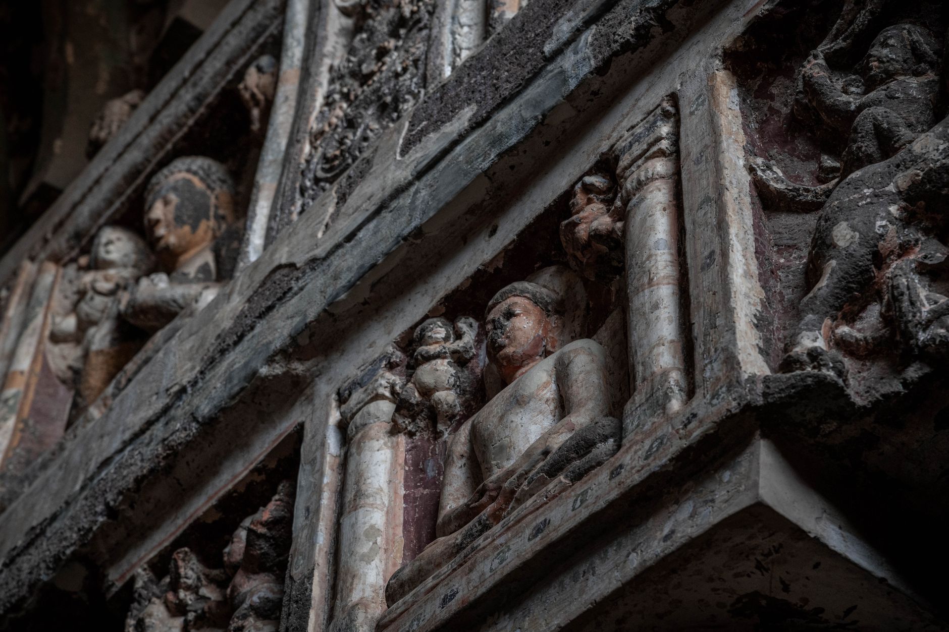 Detailed view of ancient sculptures in Ajanta Caves, showcasing historic artistry.