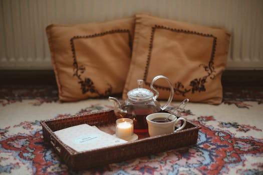 Warm and inviting tea setup with candlelight, perfect for relaxation and reading.