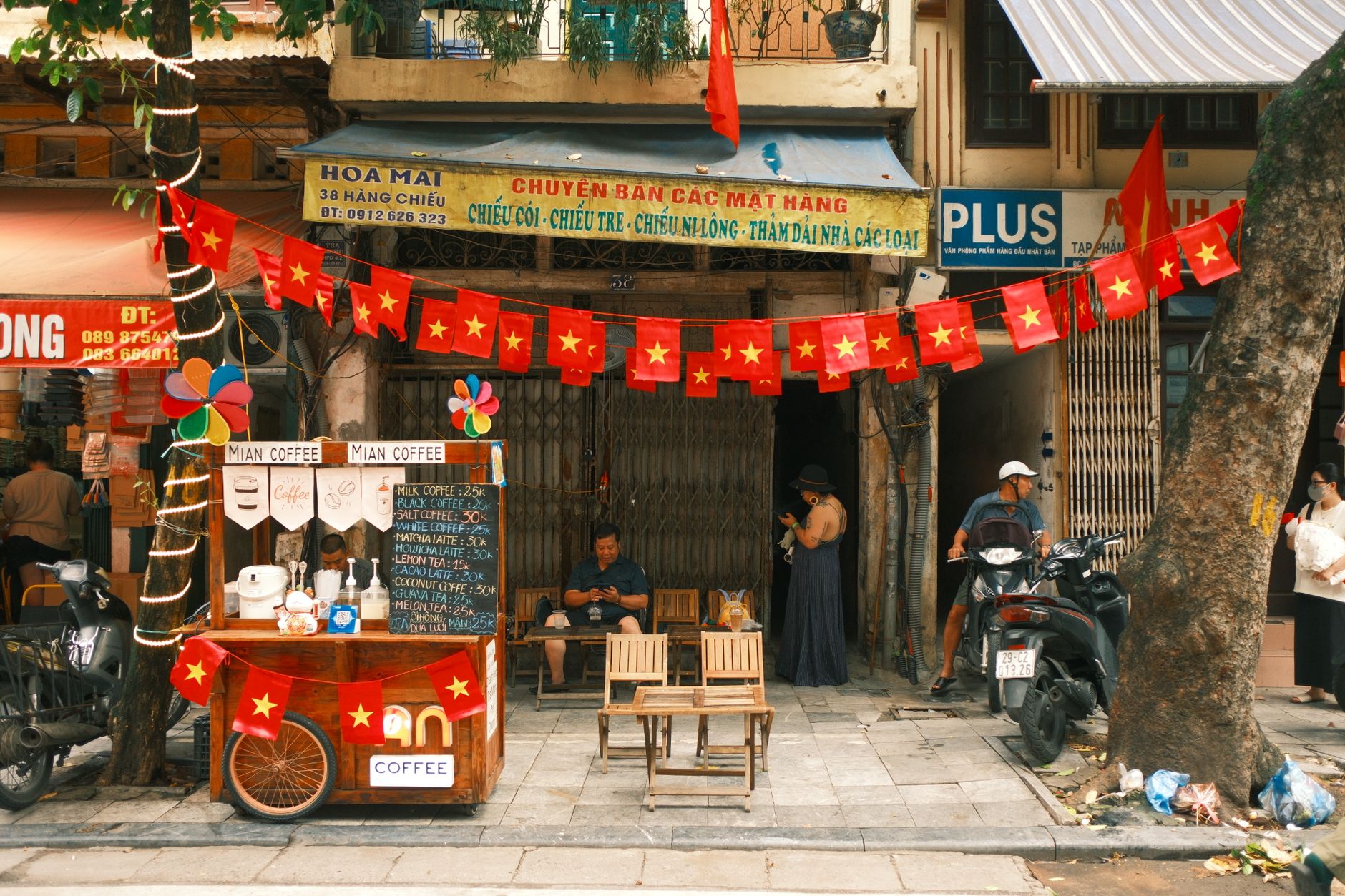 Charming Vietnamese street coffee shop with vibrant red flags creating a warm, inviting atmosphere.