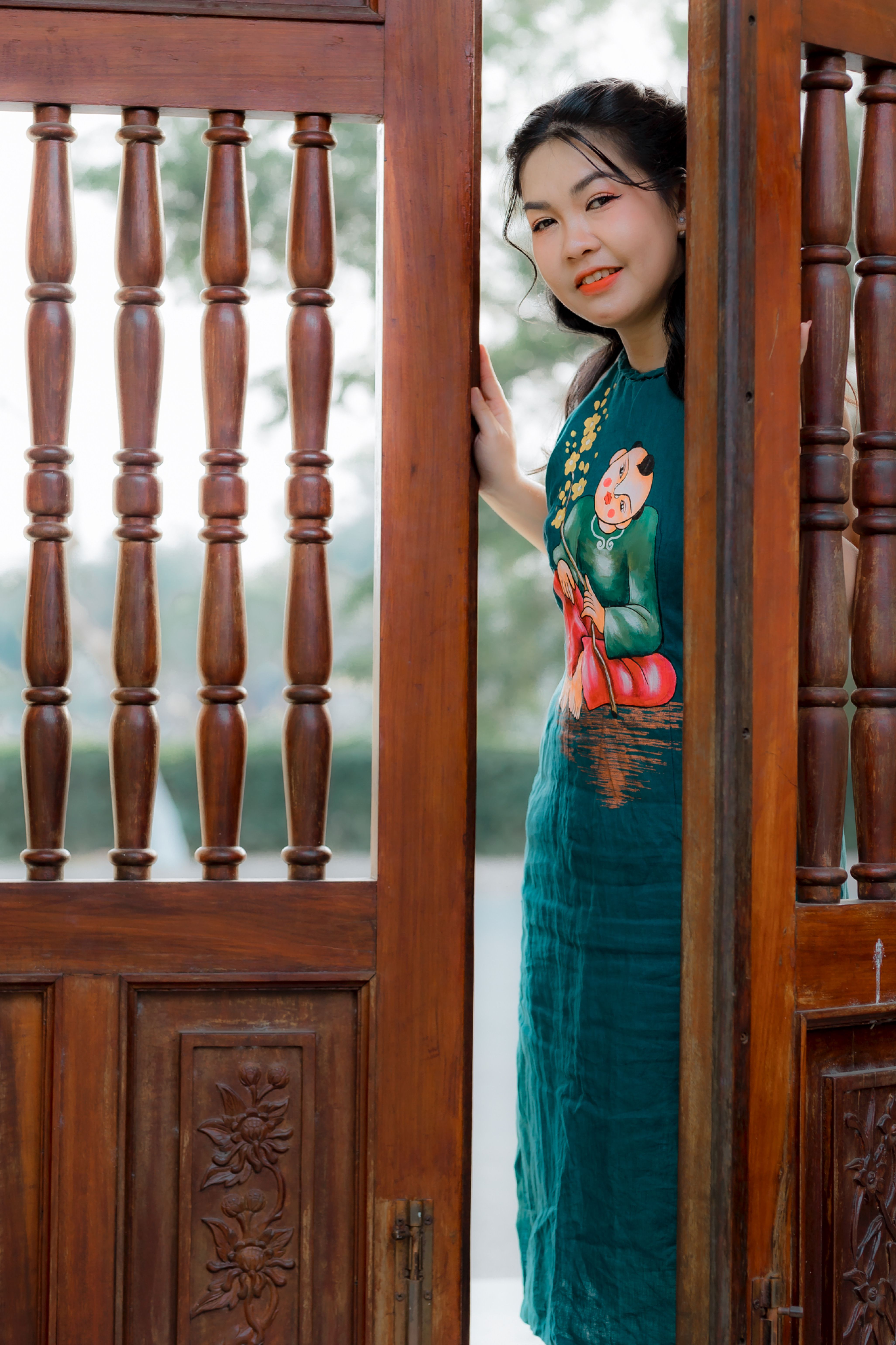Woman in Traditional Dress by Wooden Doorway · Free Stock Photo