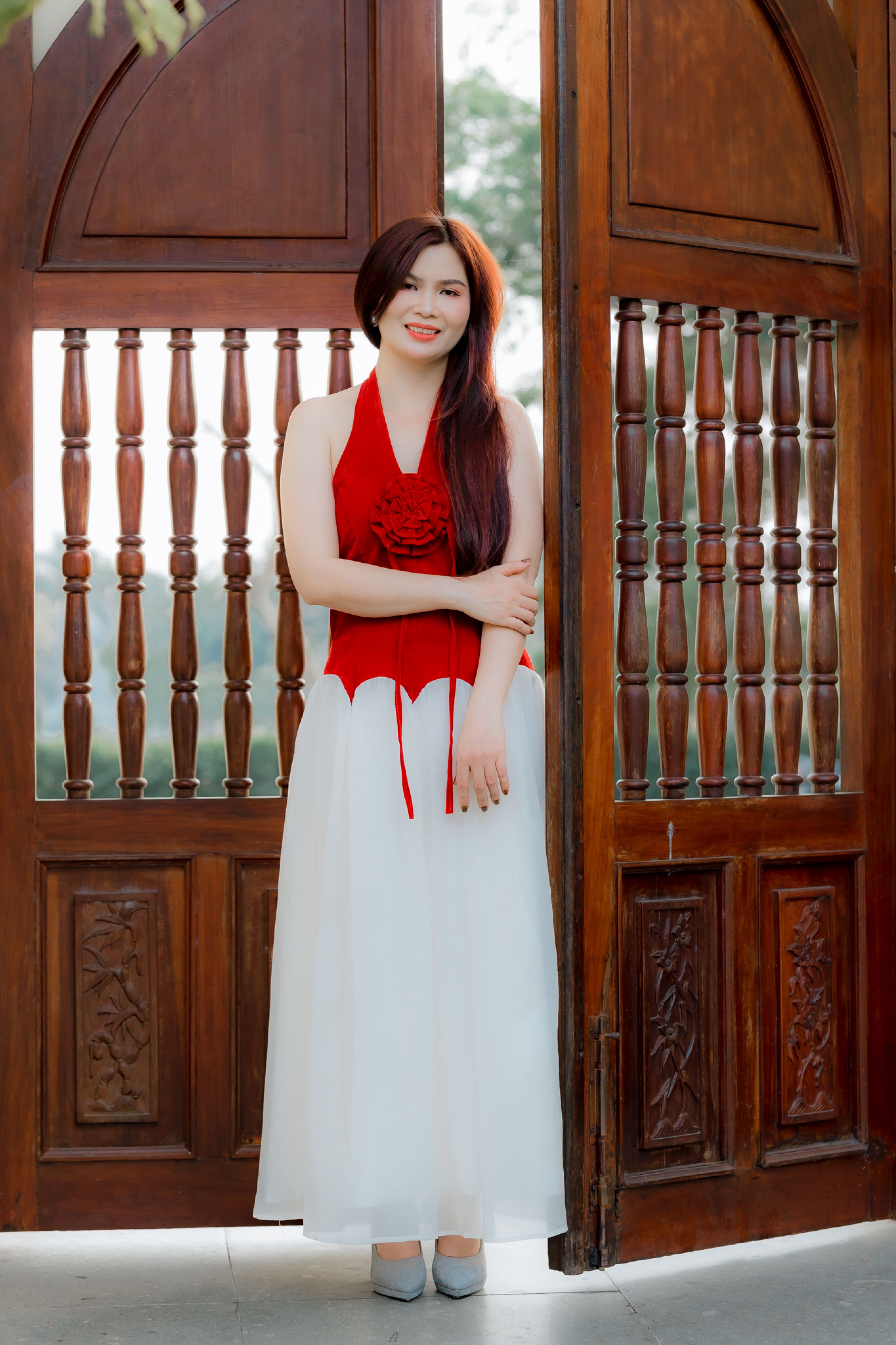 Elegant Woman in Red and White Dress by Wooden Door · Free Stock Photo