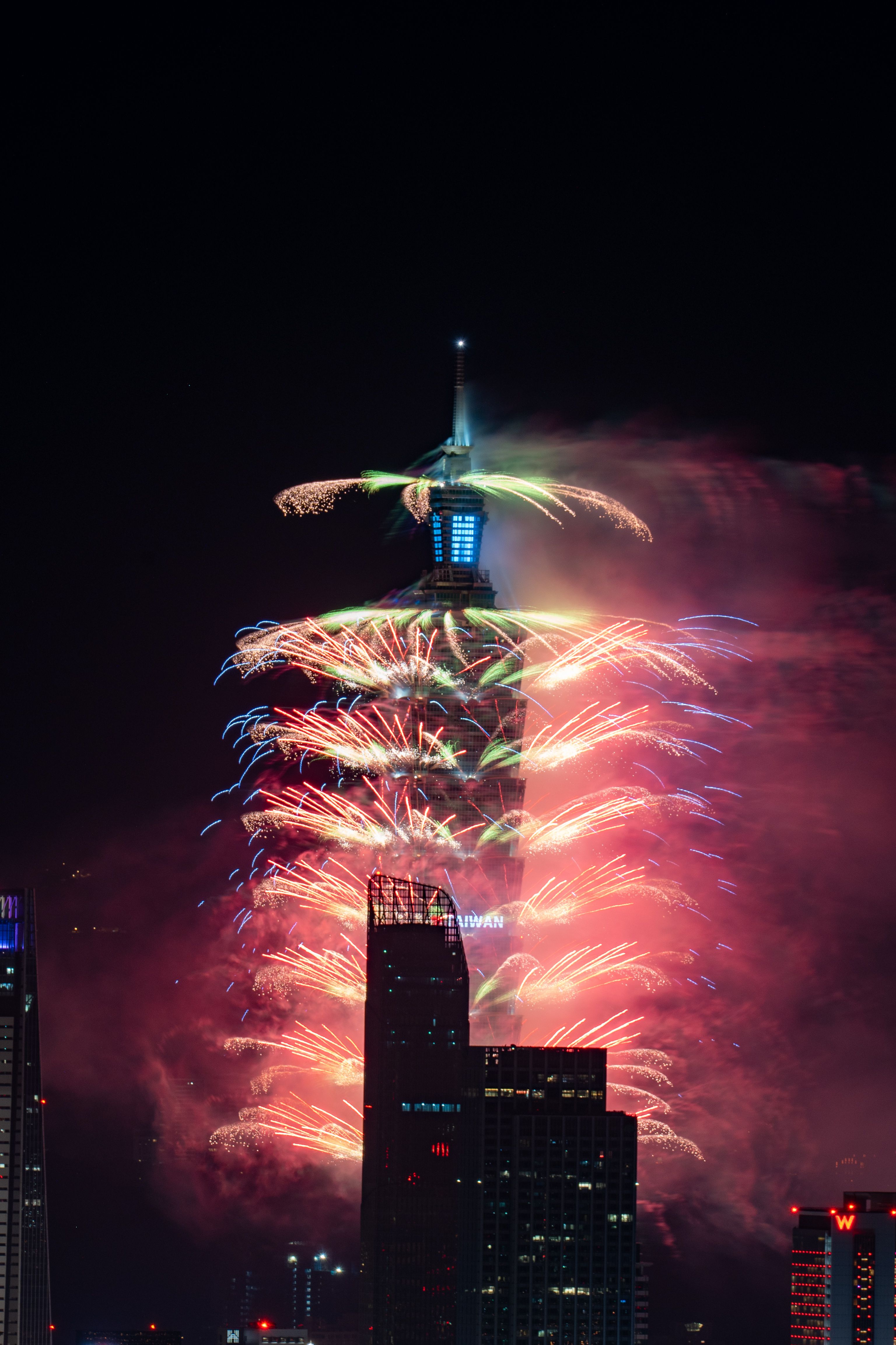 Dramatic Fireworks Display Around Iconic Tower · Free Stock Photo