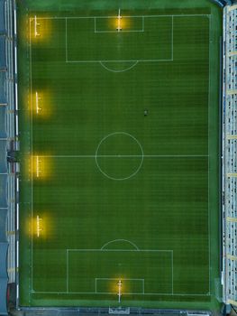 Aerial shot of an empty football stadium in Jönköping, Sweden, showcasing the field and lights.