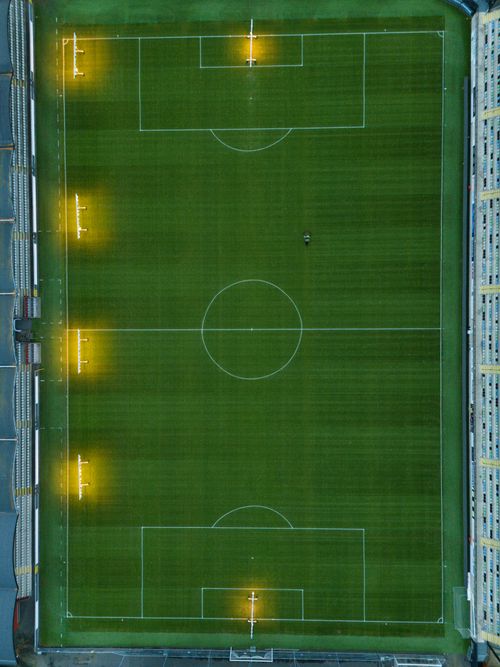 Free Aerial shot of an empty football stadium in Jönköping, Sweden, showcasing the field and lights. Stock Photo