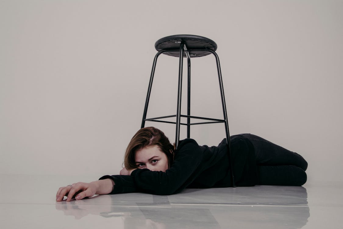 Donna In Camicia Nera A Maniche Lunghe Sdraiato Sul Pavimento