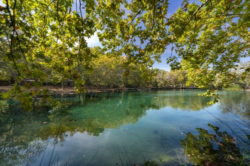 Free Tranquil lake surrounded by lush greenery in Anna, Comunidad Valenciana, Spain. Stock Photo