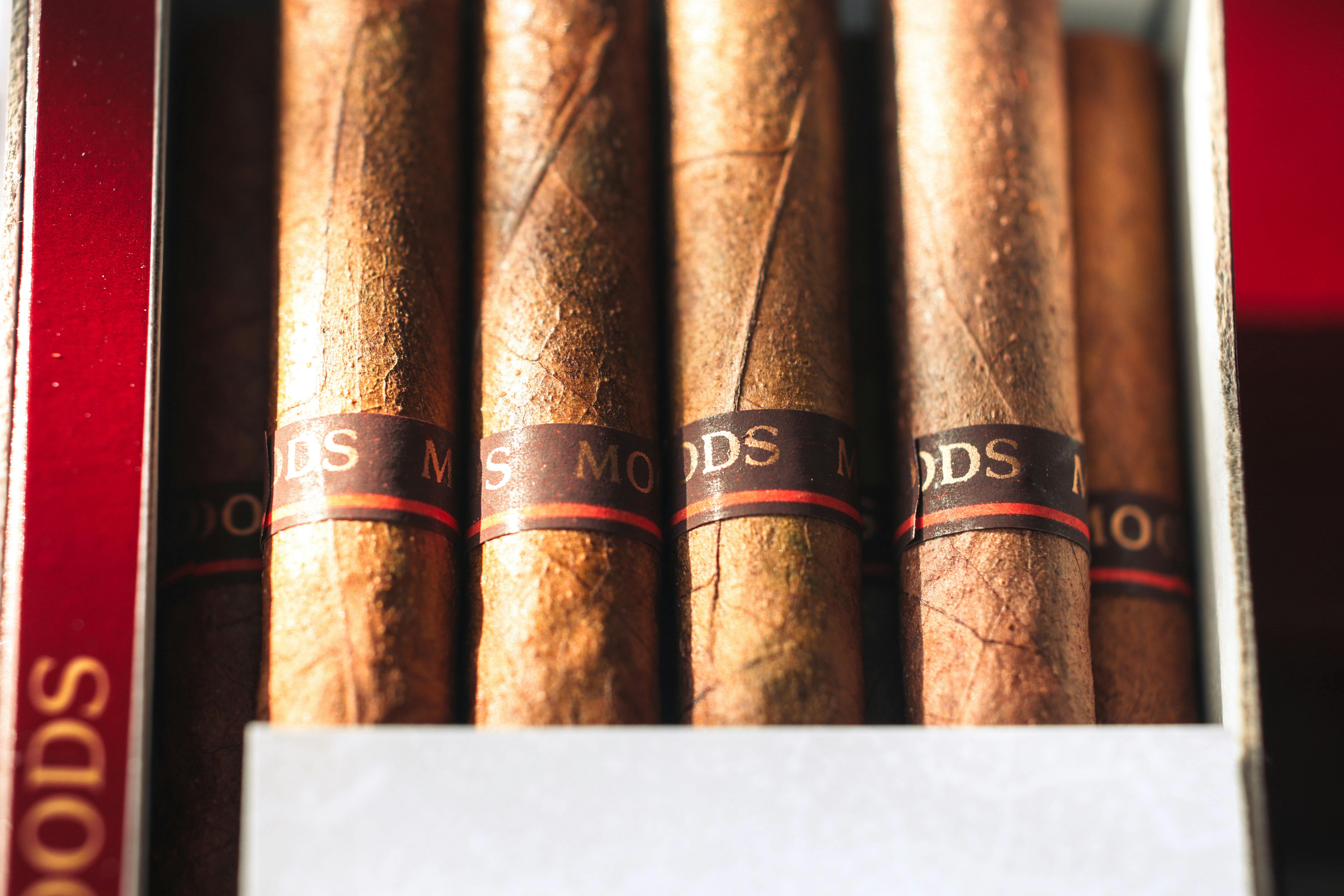 Detailed view of premium cigars with visible textures and labels in a box.