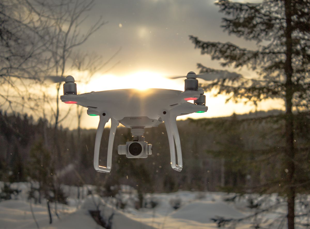 Filming drone flying low over trees on the documentary shoot