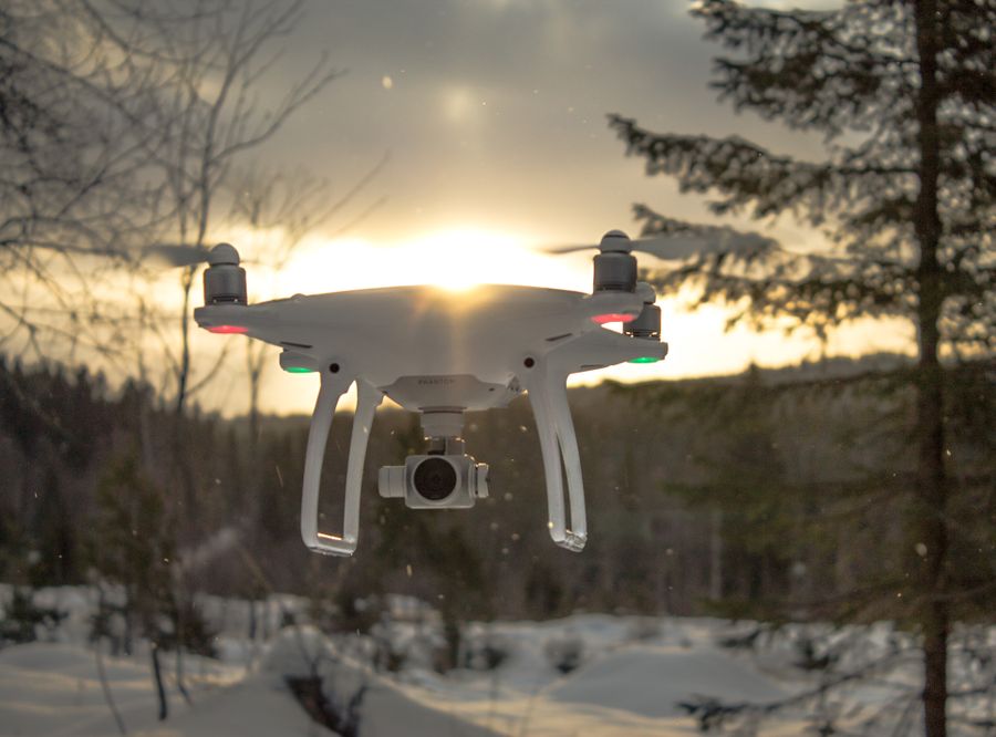 Cloudline Surveyor RTK drone in flight near trees