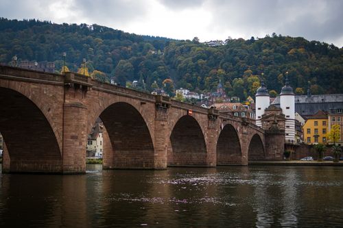 Free The scenic Heidelberg Bridge spans across the Neckar River surrounded by vibrant autumn foliage. Stock Photo