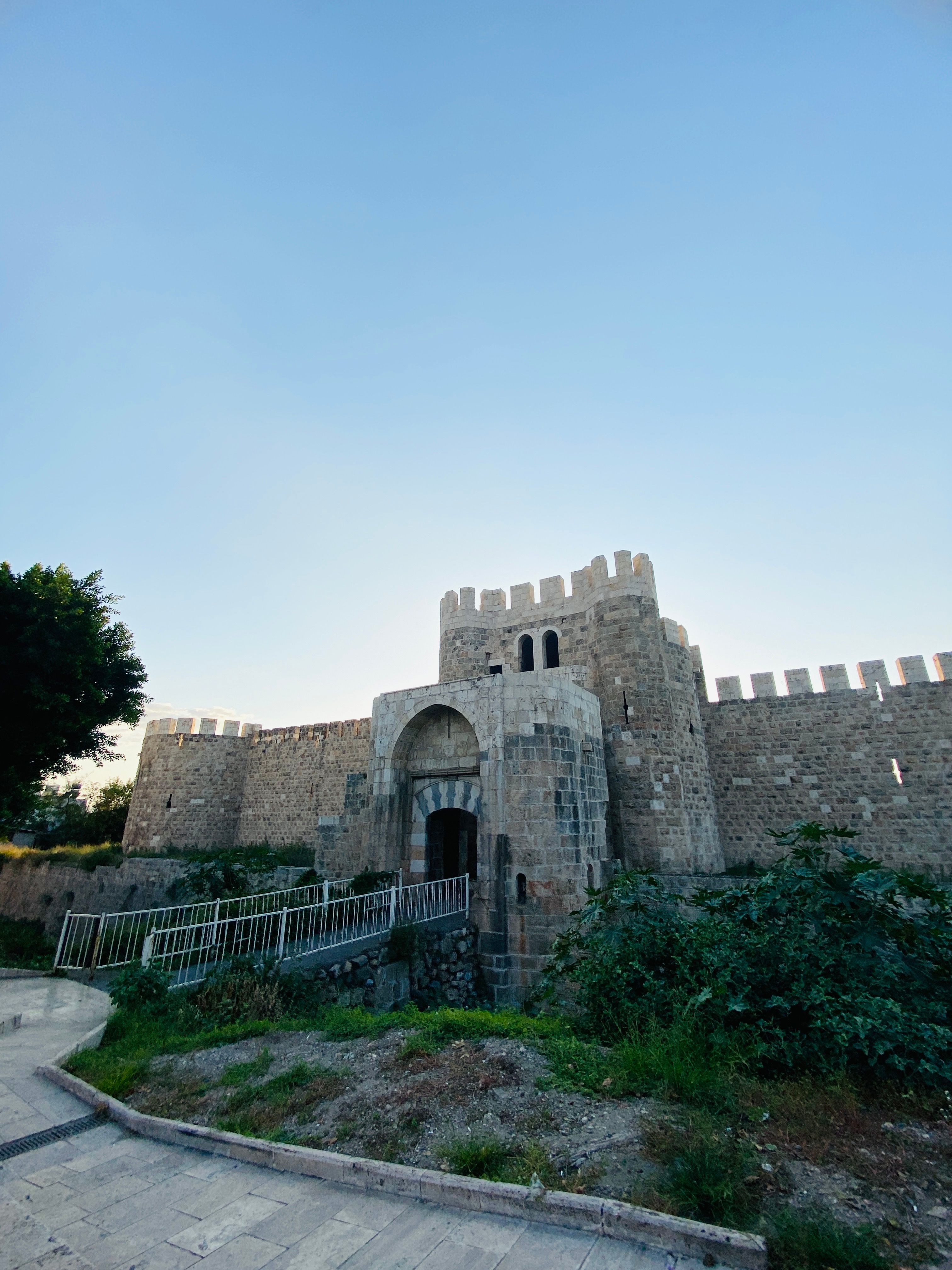 Bodrum Castle at golden hour in Turkey with medieval stone towers reflecting in turquoise Aegean waters and white-washed buildings