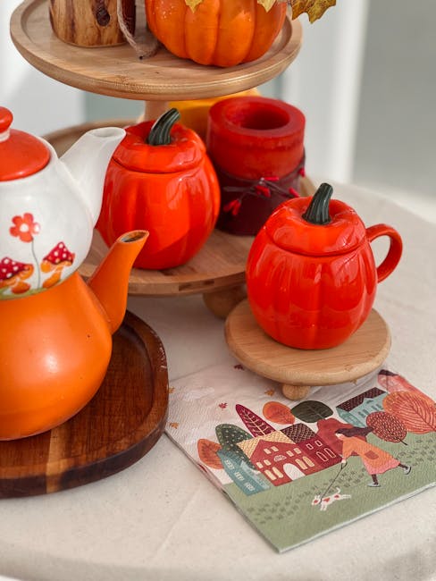 Charming fall-themed tea setup with pumpkin mugs and cozy decor.