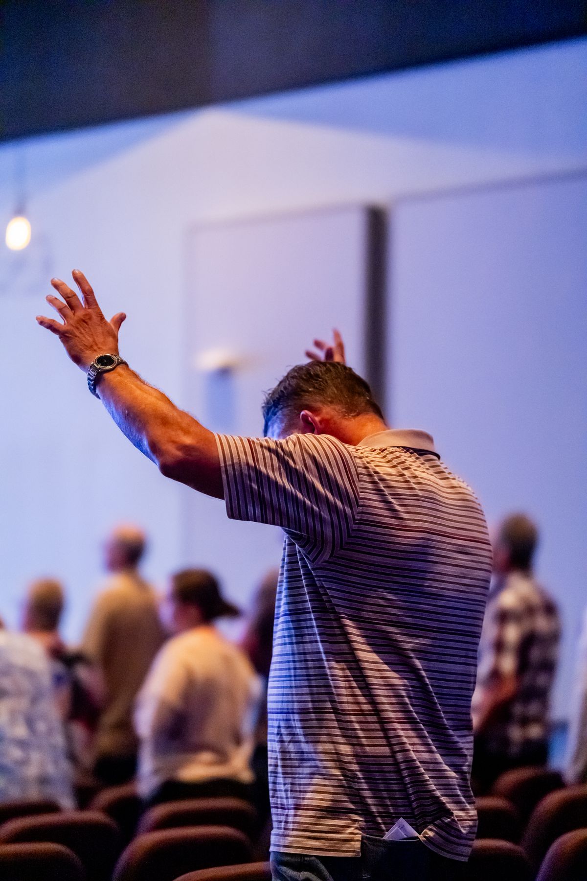 A worshipper raising a hand during a church service