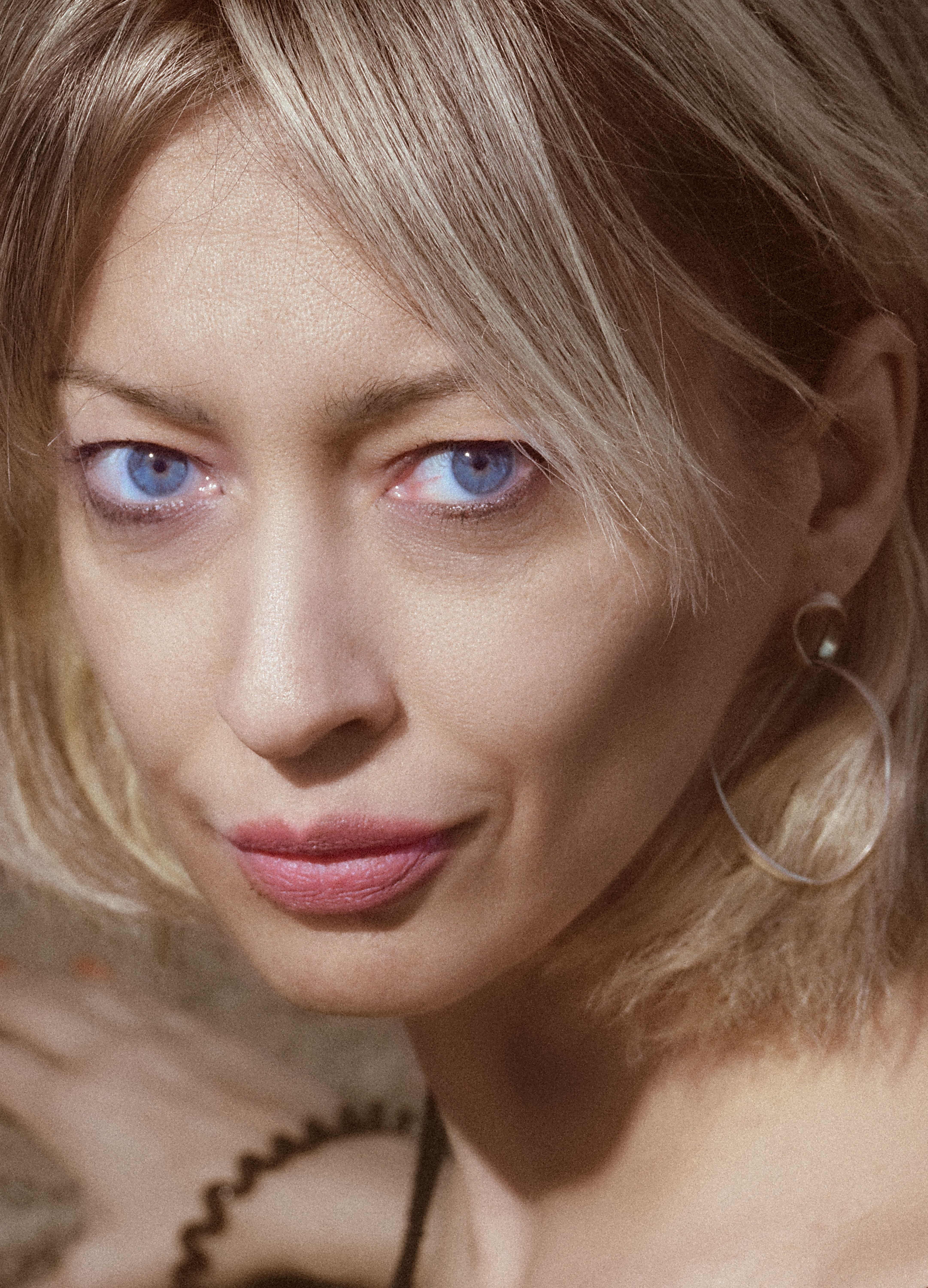 Intense close-up portrait of a woman with striking blue eyes in Kyiv, Ukraine.
