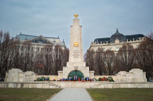 Soviet War Memorial with wreaths in Budapest, Hungary, framed by historic architecture.