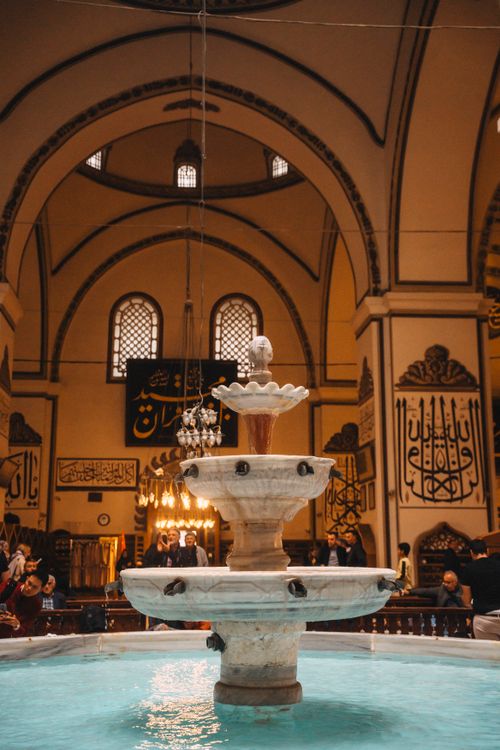 Free Explore the stunning interior of the Ulu Cami Mosque, showcasing its beautiful fountain and architectural details. Stock Photo