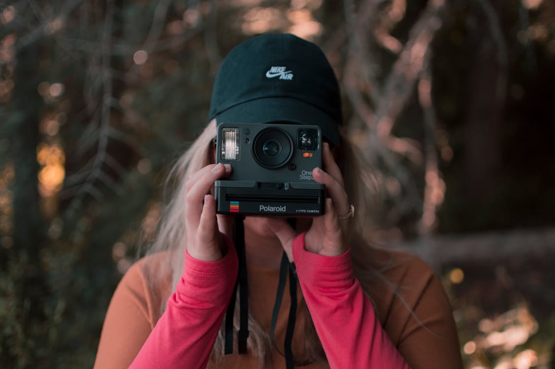 Woman Holding A Polaroid Camera