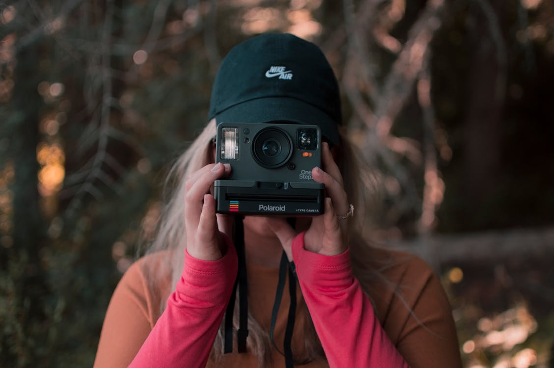 Free Woman Holding A Polaroid Camera Stock Photo