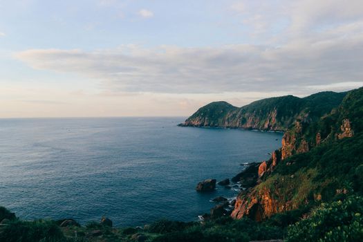 A beautiful coastal view of cliffs and ocean in Phu Yen, Vietnam at sunset.