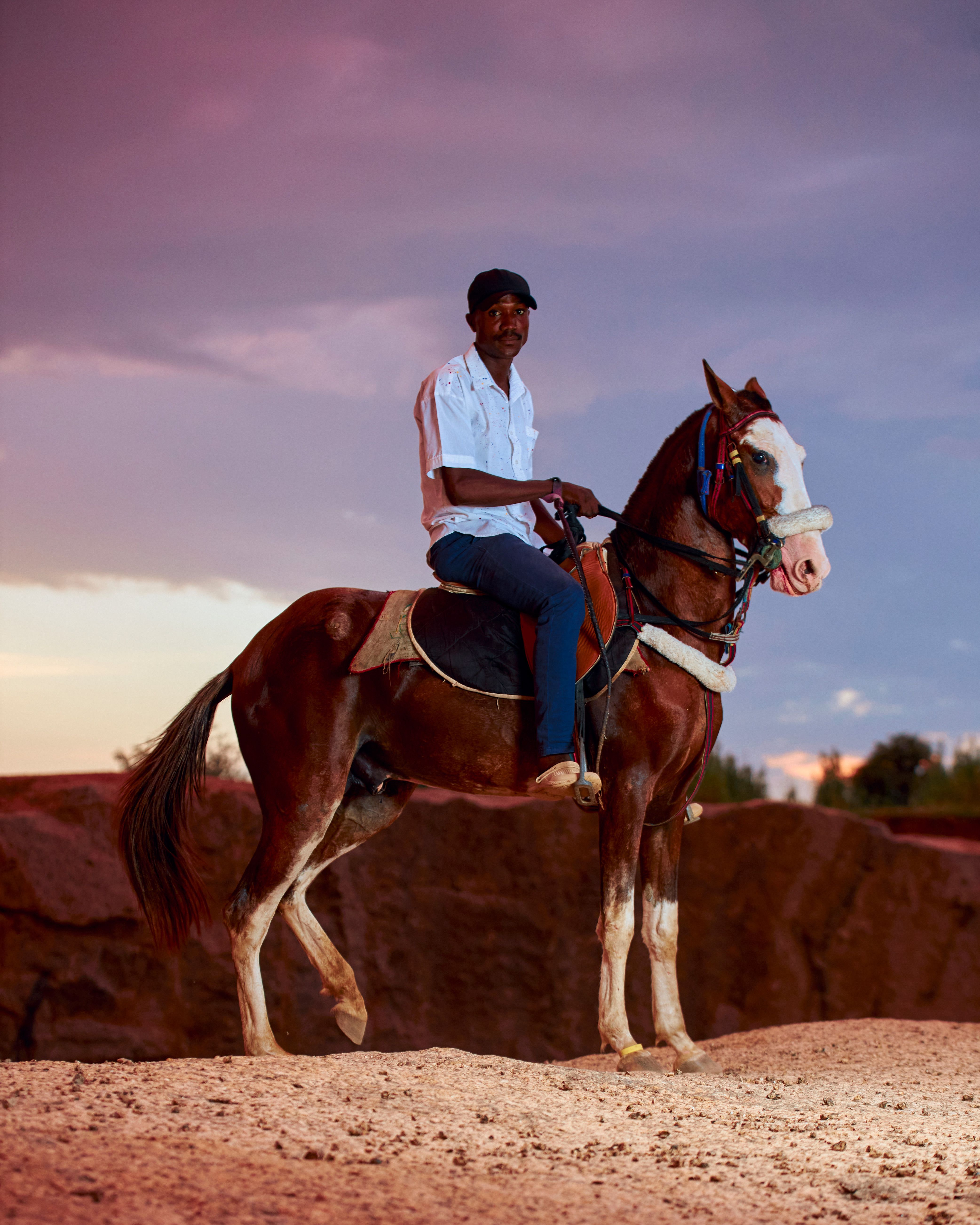 Man Riding Horse Against Vibrant Sunset Sky · Free Stock Photo