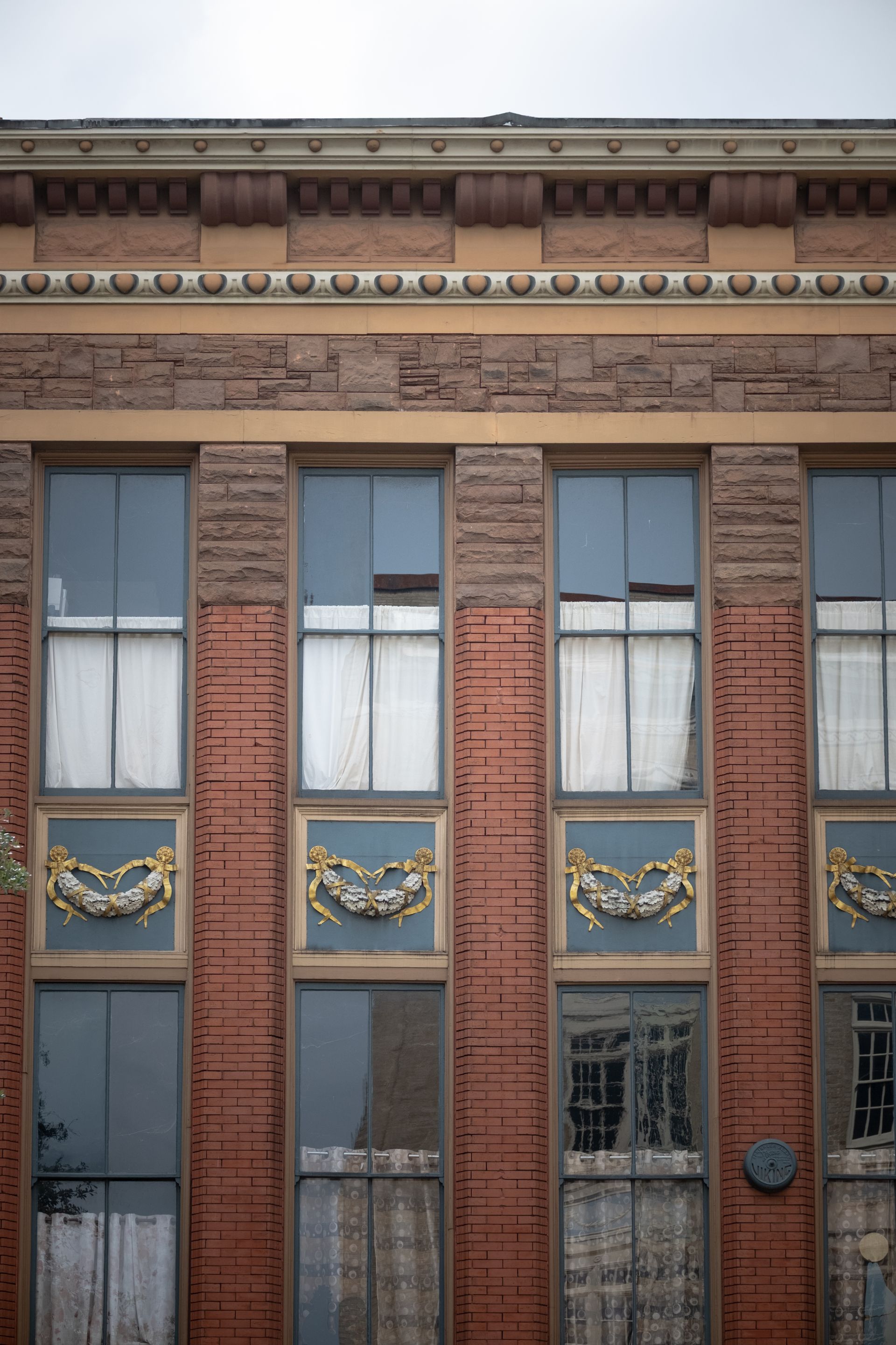 Historic brick building facade in Macon Georgia — geographic frame for revival-that-skips 