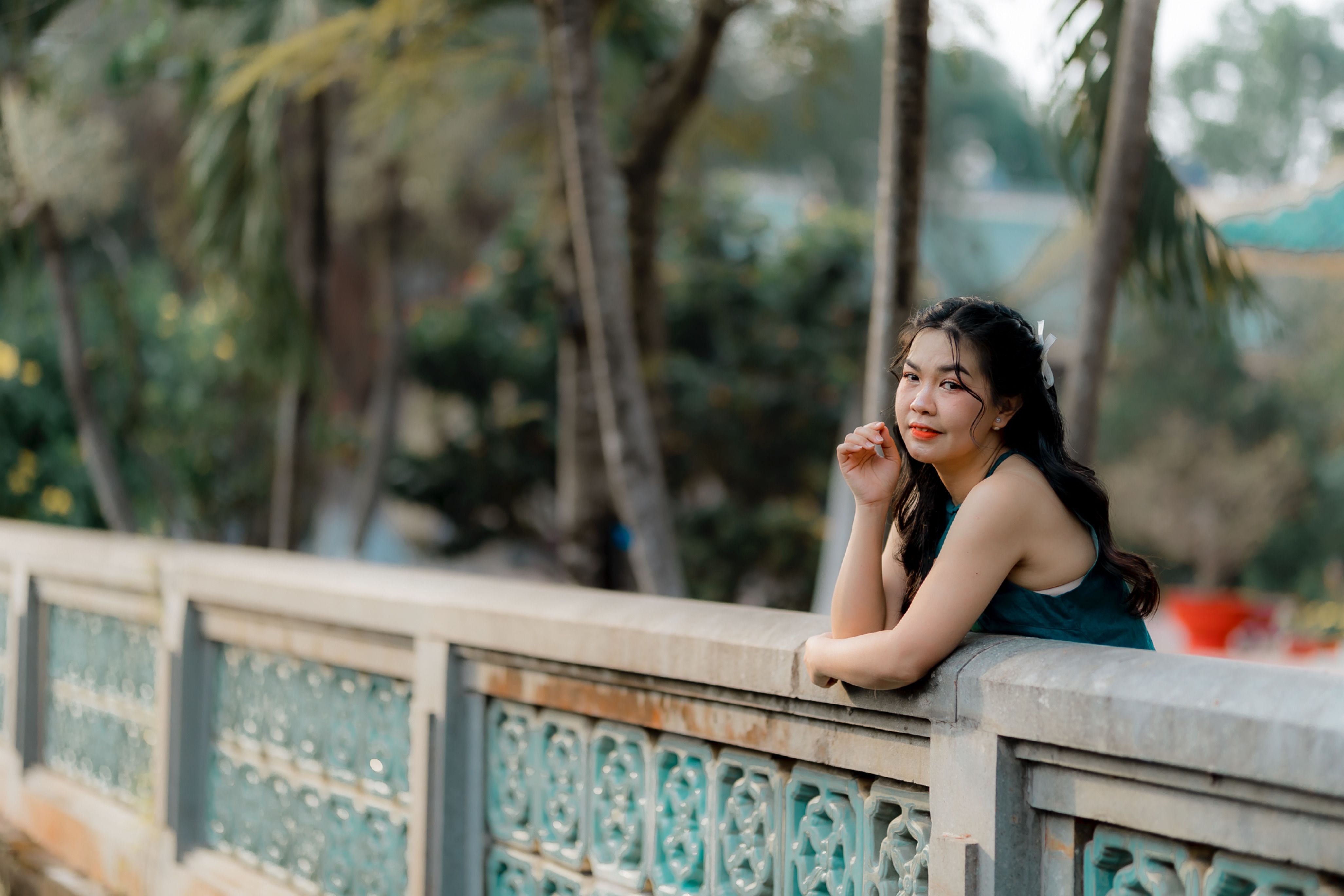 Young Woman Relaxing on Scenic Outdoor Bridge · Free Stock Photo